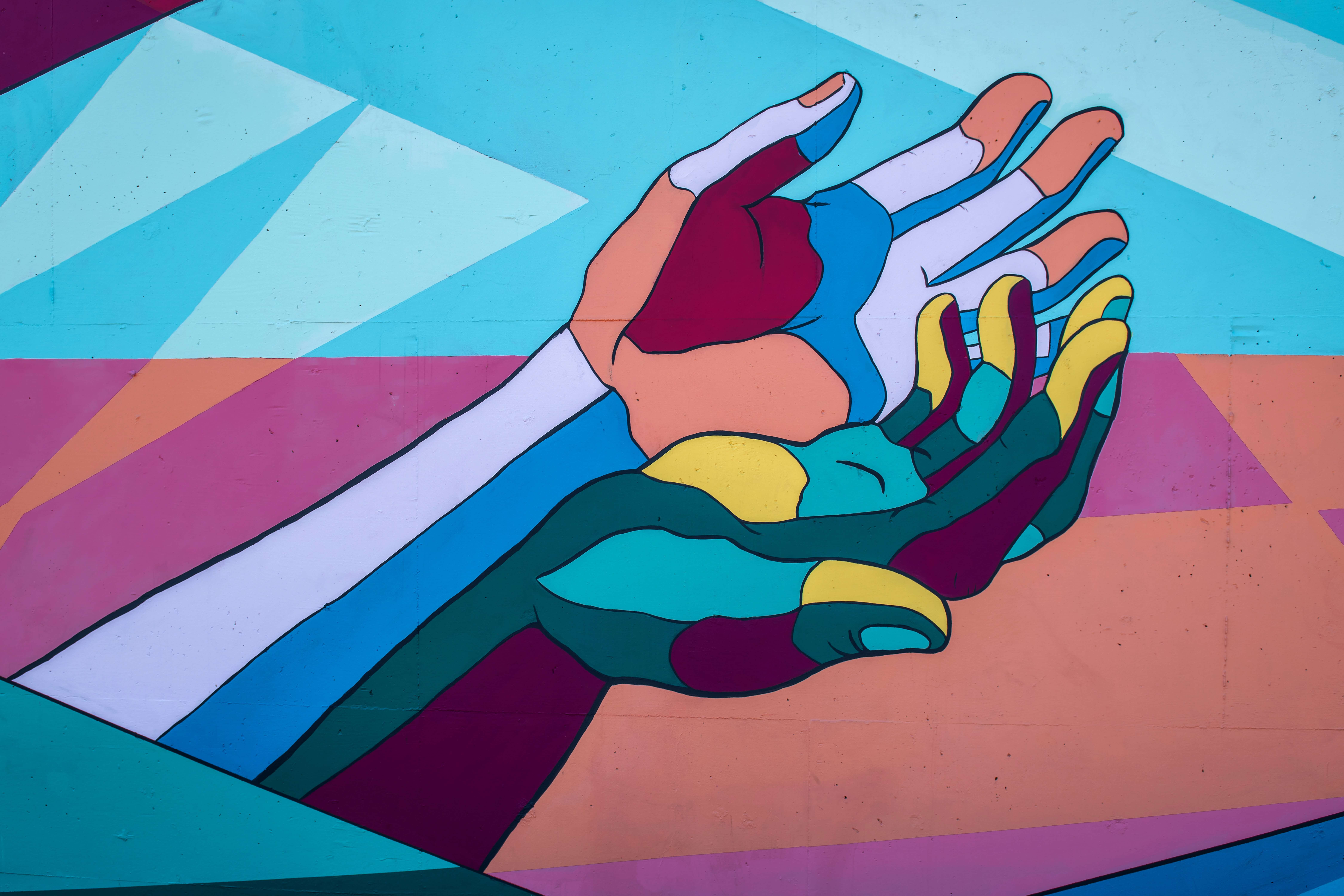 two multicoloured hands reaching out