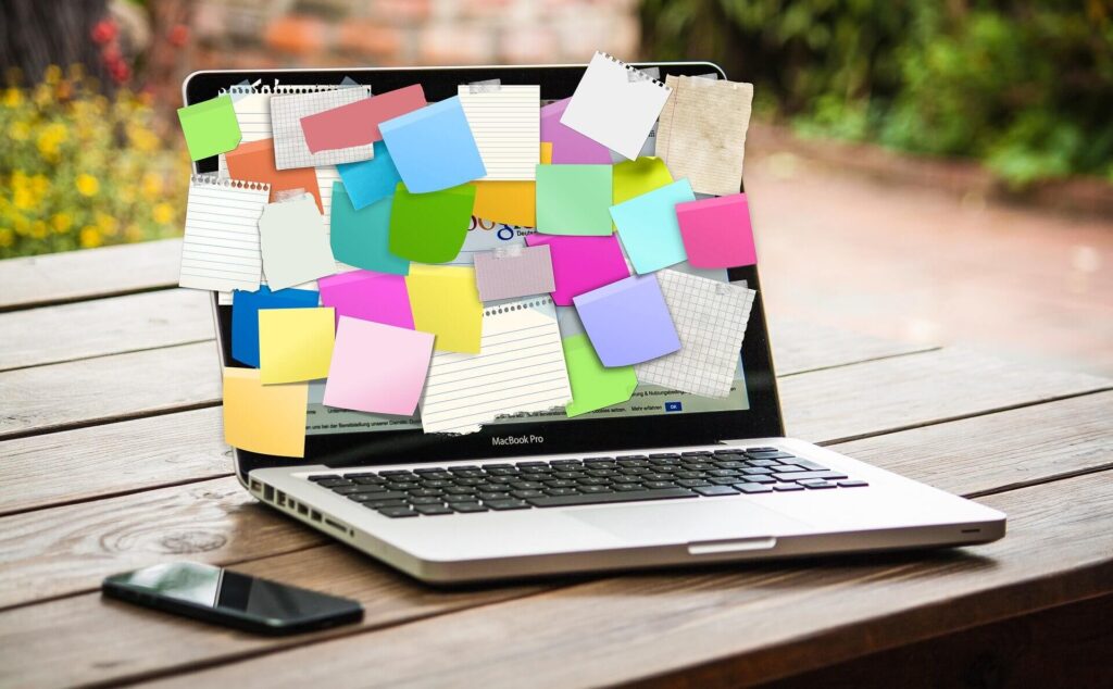 Laptop with post it notes on the screen